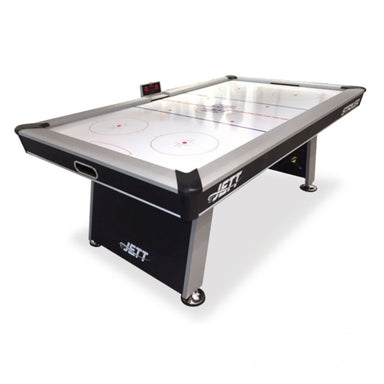 A Jet air hockey table with a black and silver frame, featuring a white play surface with red markings, shown on a white background.